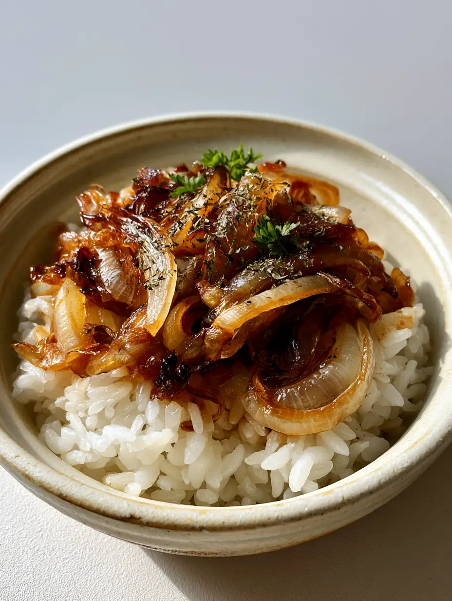 Onion Rice Recipe with Caramelized Golden Onions 3 Close-up of steamed long-grain rice and charred onions in a light ceramic bowl. (Onion Rice Recipe)